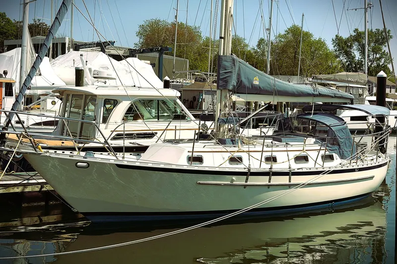 The Image of 2009 Pacific Seacraft 34 sailboat docked at a marina, surrounded by other boats. - 0