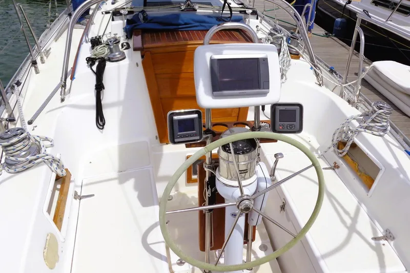 Slide: The Image of Cockpit of 2009 Pacific Seacraft 34 sailboat with steering wheel and navigation instruments. - 10