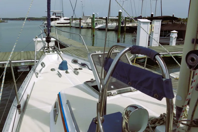Slide: The Image of 2009 Pacific Seacraft 34 sailboat docked at a marina, showcasing deck and helm. - 7