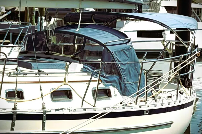 Slide: The Image of 2009 Pacific Seacraft 34 sailboat docked with blue canopy and railing. - 8