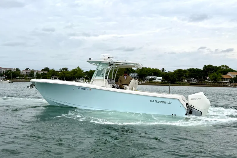The Image of 2021 Sailfish 290 CC boat cruising on water with scenic shoreline background. - 0