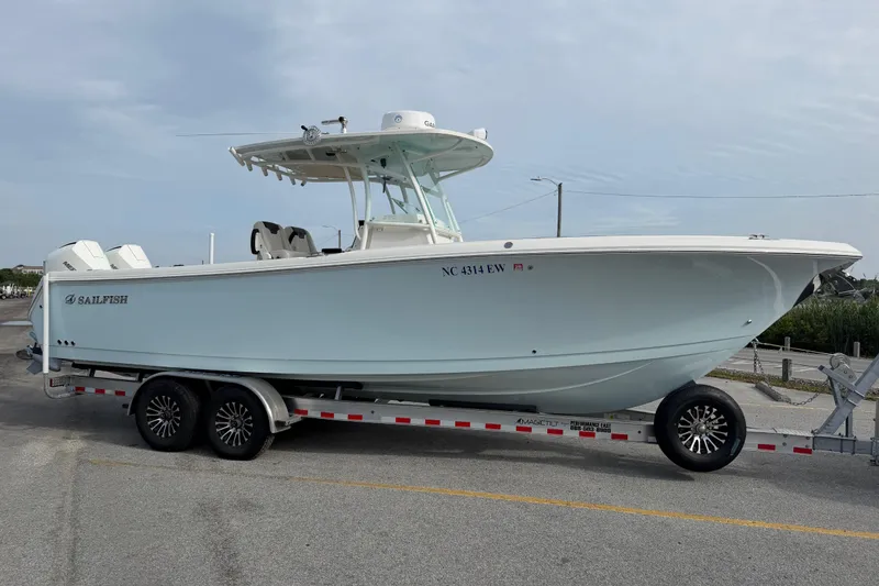 Slide: The Image of 2021 Sailfish 290 CC boat on trailer, side view, parked on road. - 15