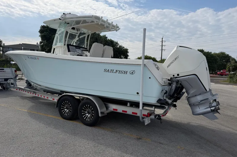 Slide: The Image of 2021 Sailfish 290 CC boat on trailer with Mercury outboard motor. - 18