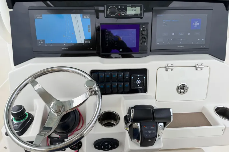 Slide: The Image of 2021 Sailfish 290 CC helm with advanced navigation and control systems. - 23