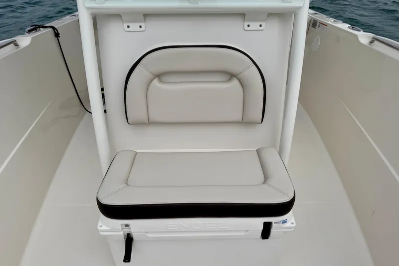 Slide: The Image of 2021 Sailfish 290 CC boat seat with cushioned backrest and storage compartment. - 26