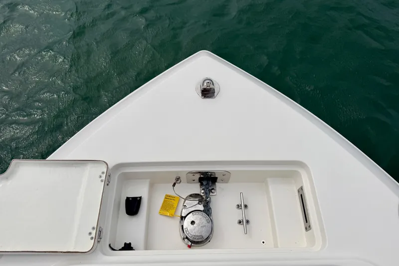 Slide: The Image of Bow of 2021 Sailfish 290 CC boat with anchor compartment, on calm water. - 27