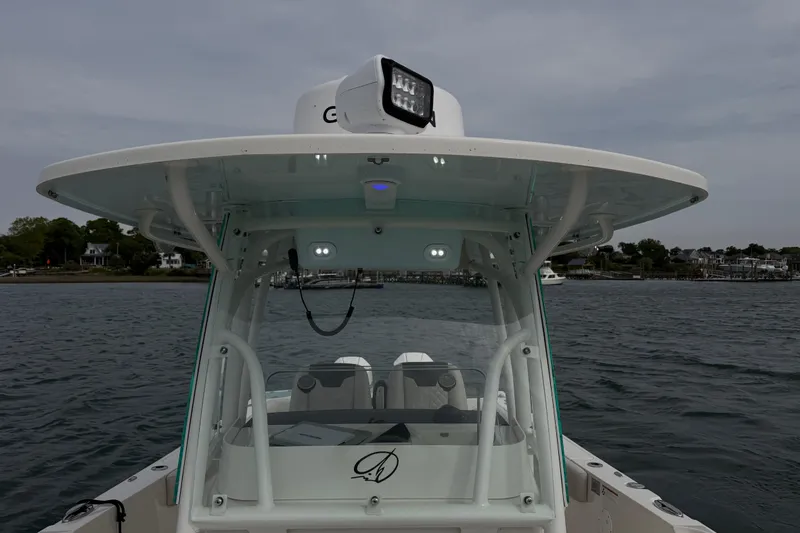 Slide: The Image of 2021 Sailfish 290 CC boat on water, featuring a sleek design and advanced lighting. - 28