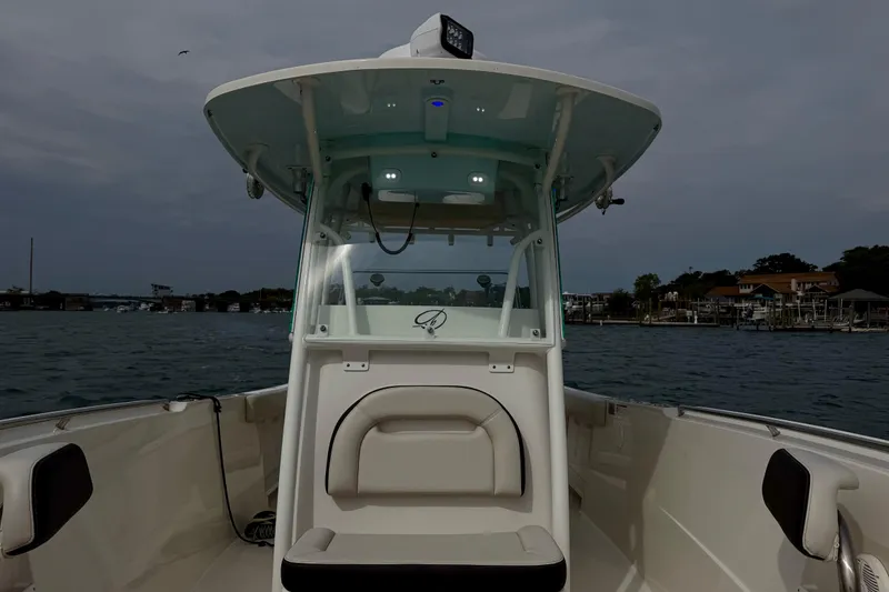 Slide: The Image of 2021 Sailfish 290 CC boat on water, featuring center console and seating. - 29