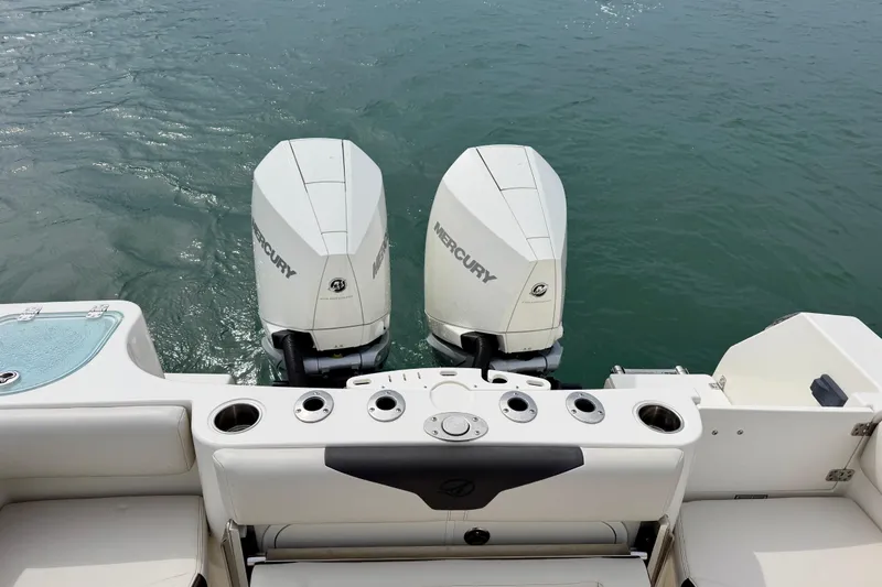 Slide: The Image of 2021 Sailfish 290 CC boat with dual Mercury outboard engines on water. - 30