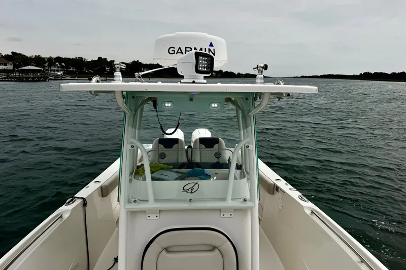 Slide: The Image of 2021 Sailfish 290 CC boat on water, featuring Garmin equipment and sleek design. - 31