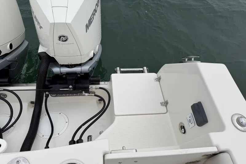 Slide: The Image of 2021 Sailfish 290 CC boat with dual Mercury outboard engines on water. - 34