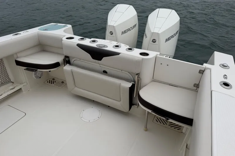 Slide: The Image of 2021 Sailfish 290 CC boat interior with seating and dual Mercury engines. - 35