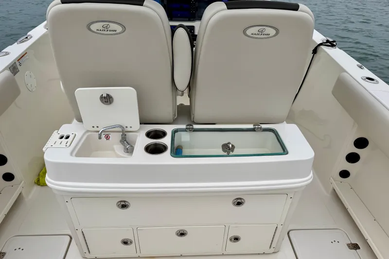 Slide: The Image of 2021 Sailfish 290 CC boat interior with sink, storage, and seating. - 36