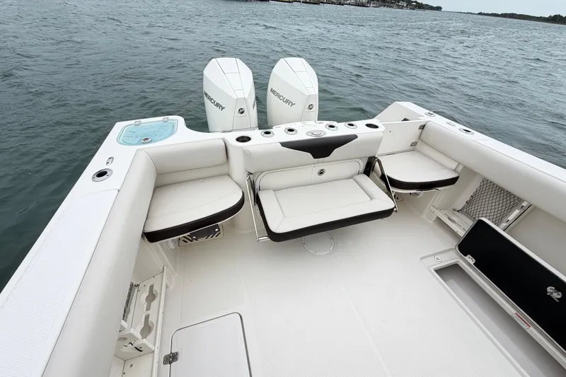 Slide: The Image of 2021 Sailfish 290 CC boat interior with seating and dual Mercury engines. - 37