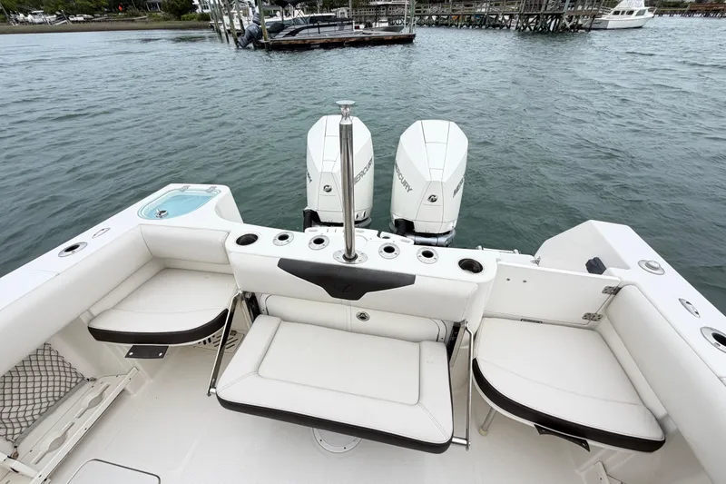 Slide: The Image of 2021 Sailfish 290 CC boat interior with seating and twin Mercury engines. - 39