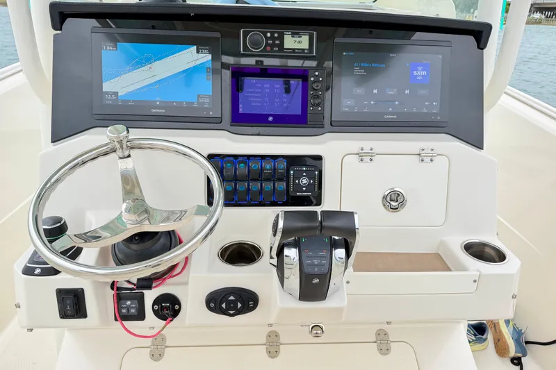 Slide: The Image of Helm of 2021 Sailfish 290 CC boat with advanced navigation and control systems. - 41