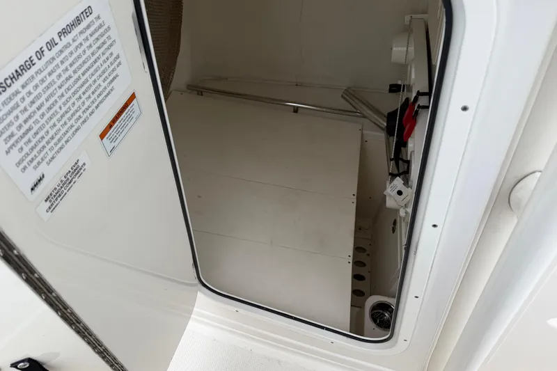 Slide: The Image of Interior view of a 2021 Sailfish 290 CC boat compartment with safety instructions. - 42