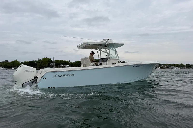Slide: The Image of 2021 Sailfish 290 CC boat cruising on water with Mercury engine. - 44
