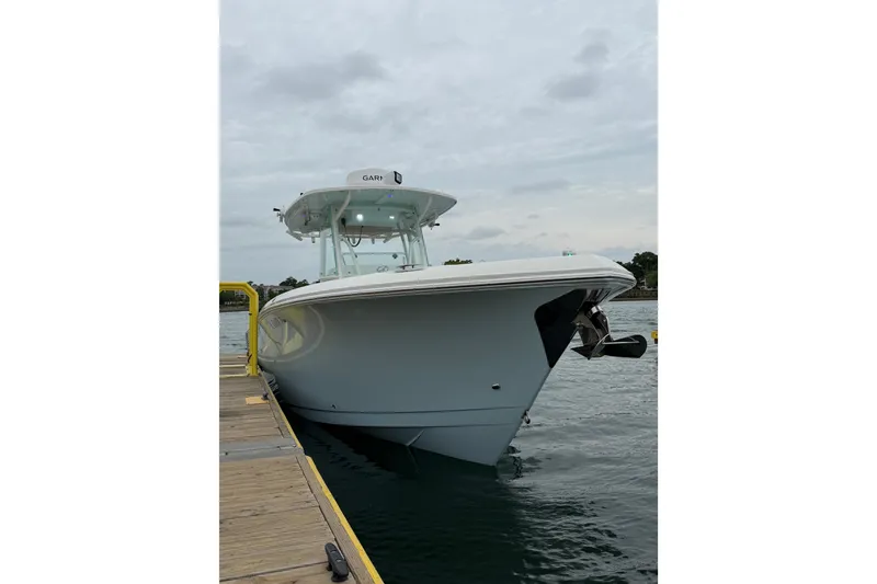 Slide: The Image of 2021 Sailfish 290 CC boat docked on a cloudy day. - 5