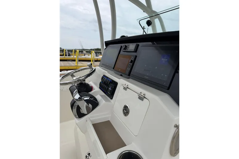 Slide: The Image of 2021 Sailfish 290 CC boat dashboard with modern navigation and control systems. - 8