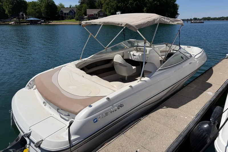 Slide: The Image of 1998 Four Winns 220 Horizon boat docked on a serene lake with canopy. - 10