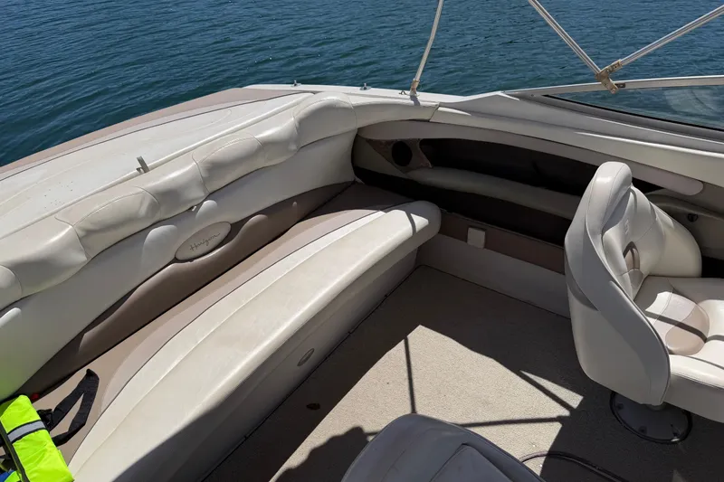 Slide: The Image of Interior of a 1998 Four Winns 220 Horizon boat with white seating and lake view. - 11