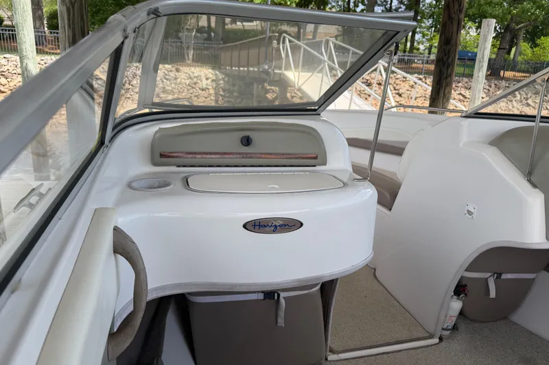 Slide: The Image of Interior of a 1998 Four Winns 220 Horizon boat, featuring seating and storage areas. - 15