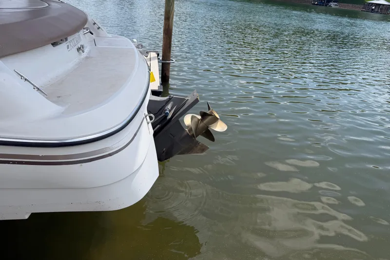 Slide: The Image of 1998 Four Winns 220 Horizon boat stern and propeller on calm water. - 18
