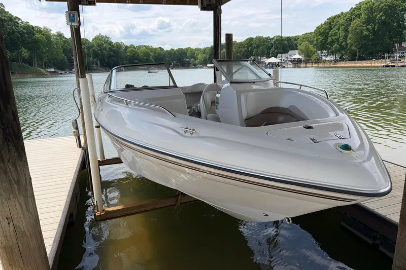 Slide: The Image of 1998 Four Winns 220 Horizon boat docked on a serene lake. - 21