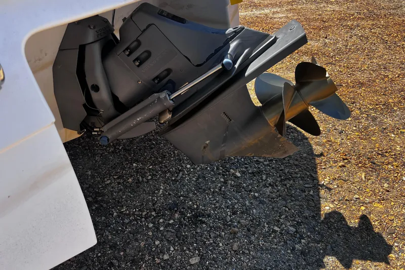 Slide: The Image of Close-up of a 1998 Four Winns 220 Horizon boat propeller on gravel surface. - 4