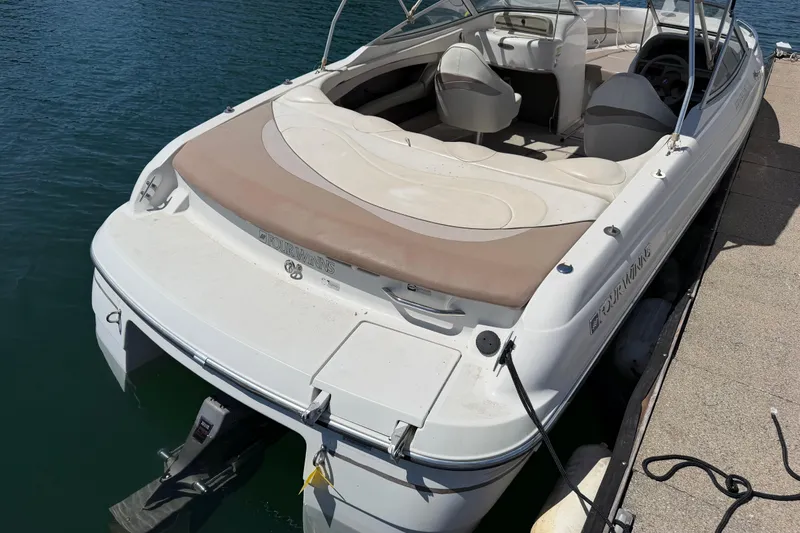 Slide: The Image of 1998 Four Winns 220 Horizon boat docked on calm water. - 9