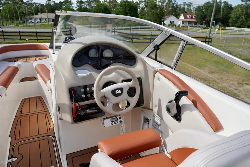 Slide: The Image of Interior of a 2001 Stingray 240 LS boat with tan and white seating. - 14