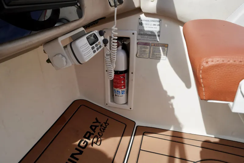 Slide: The Image of Interior of a 2001 Stingray 240 LS boat with fire extinguisher and radio. - 15