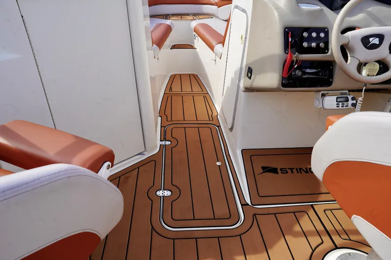 Slide: The Image of 2001 Stingray 240 LS boat interior with teak flooring and leather seating. - 16