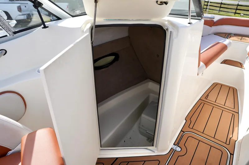 Slide: The Image of 2001 Stingray 240 LS boat interior with open cabin door and seating area. - 20