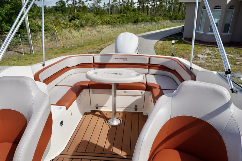 Slide: The Image of Interior of a 2001 Stingray 240 LS boat with cushioned seating and table. - 23