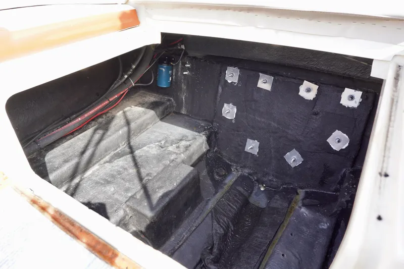 Slide: The Image of Interior view of a 2001 Stingray 240 LS boat compartment, showing wiring and structural details. - 25