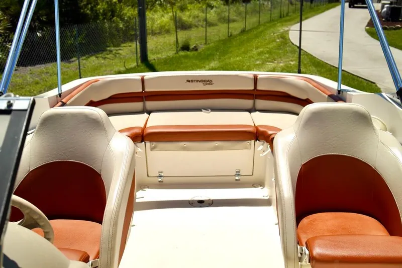 Slide: The Image of Interior of a 2001 Stingray 240 LS boat with tan and brown seating. - 9