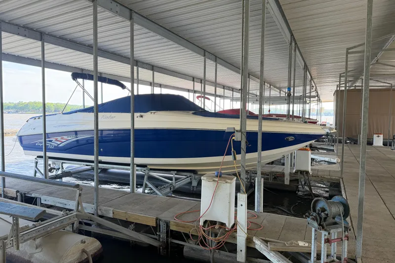 The Image of 2005 Rinker 282 Captiva Bowrider in dock, covered and elevated, blue and white design. - 1