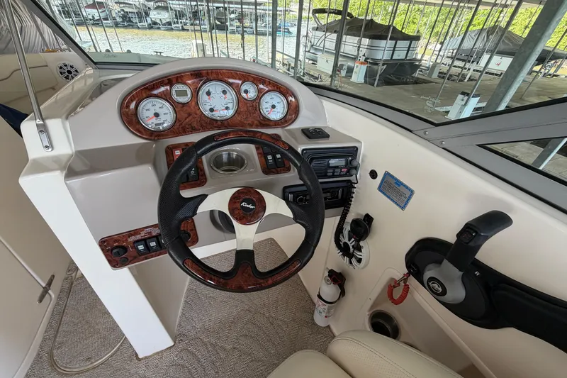Slide: The Image of 2005 Rinker 282 Captiva Bowrider helm with gauges, steering wheel, and controls. - 13