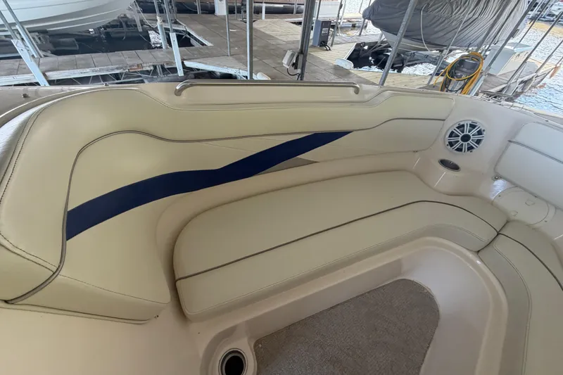 Slide: The Image of 2005 Rinker 282 Captiva Bowrider interior seating with beige upholstery and blue accent. - 18