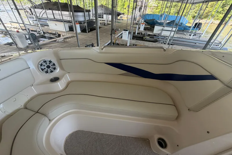 Slide: The Image of 2005 Rinker 282 Captiva Bowrider interior with beige seating and blue accent. - 19