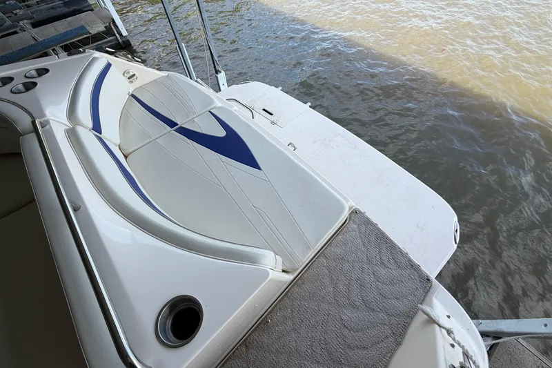 Slide: The Image of 2005 Rinker 282 Captiva Bowrider boat with stylish seating and water view. - 4