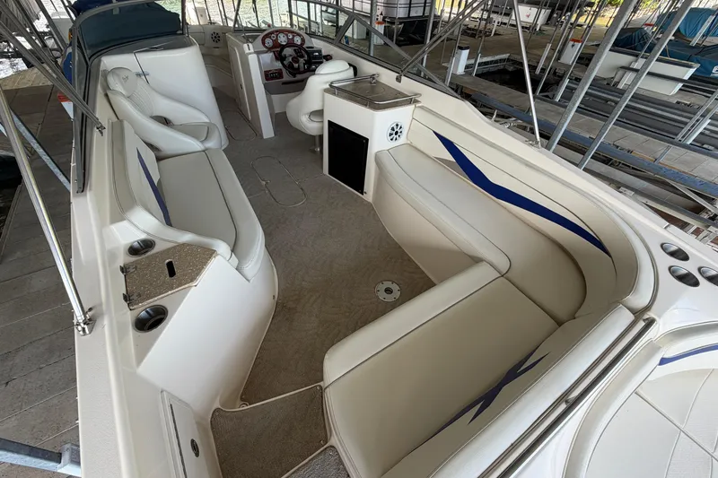 Slide: The Image of 2005 Rinker 282 Captiva Bowrider interior with spacious seating and modern dashboard. - 6