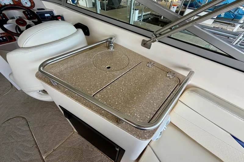 Slide: The Image of 2005 Rinker 282 Captiva Bowrider interior with helm and countertop sink. - 9