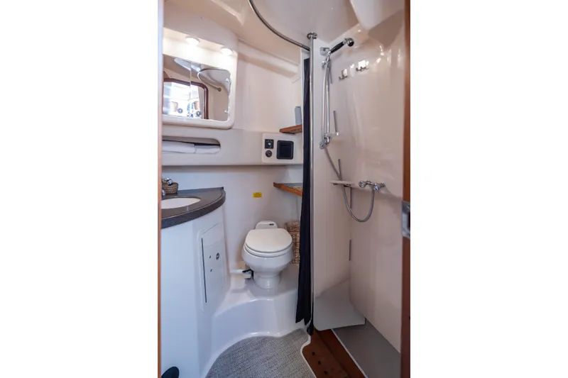Slide: The Image of 2006 Grady-White Express 360 boat bathroom with shower, sink, and toilet. - 32