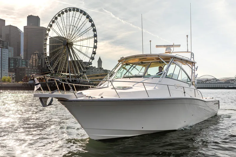 Slide: The Image of 2006 Grady-White Express 360 boat cruising near city skyline and Ferris wheel. - 34