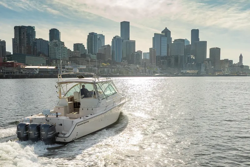 Slide: The Image of 2006 Grady-White Express 360 boat cruising near city skyline on sunny day. - 35