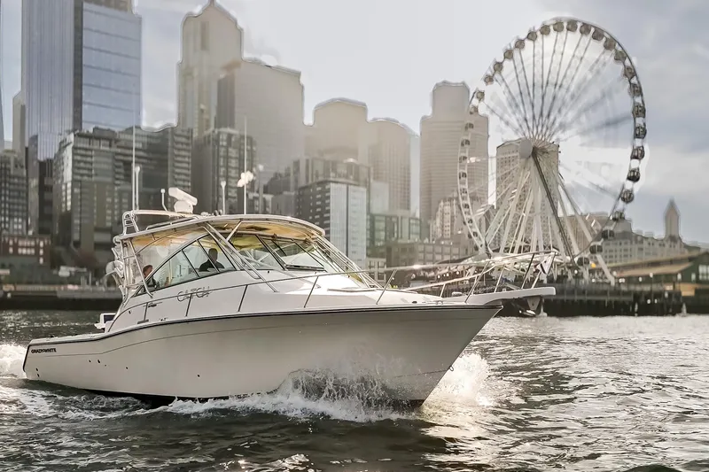 Slide: The Image of 2006 Grady-White Express 360 boat cruising near city skyline and Ferris wheel. - 6