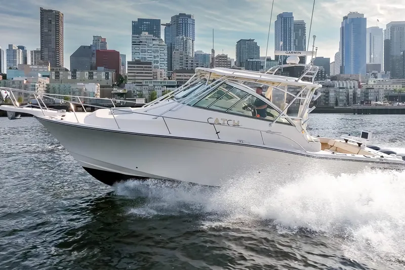 Slide: The Image of 2006 Grady-White Express 360 cruising near city skyline, creating waves. - 7